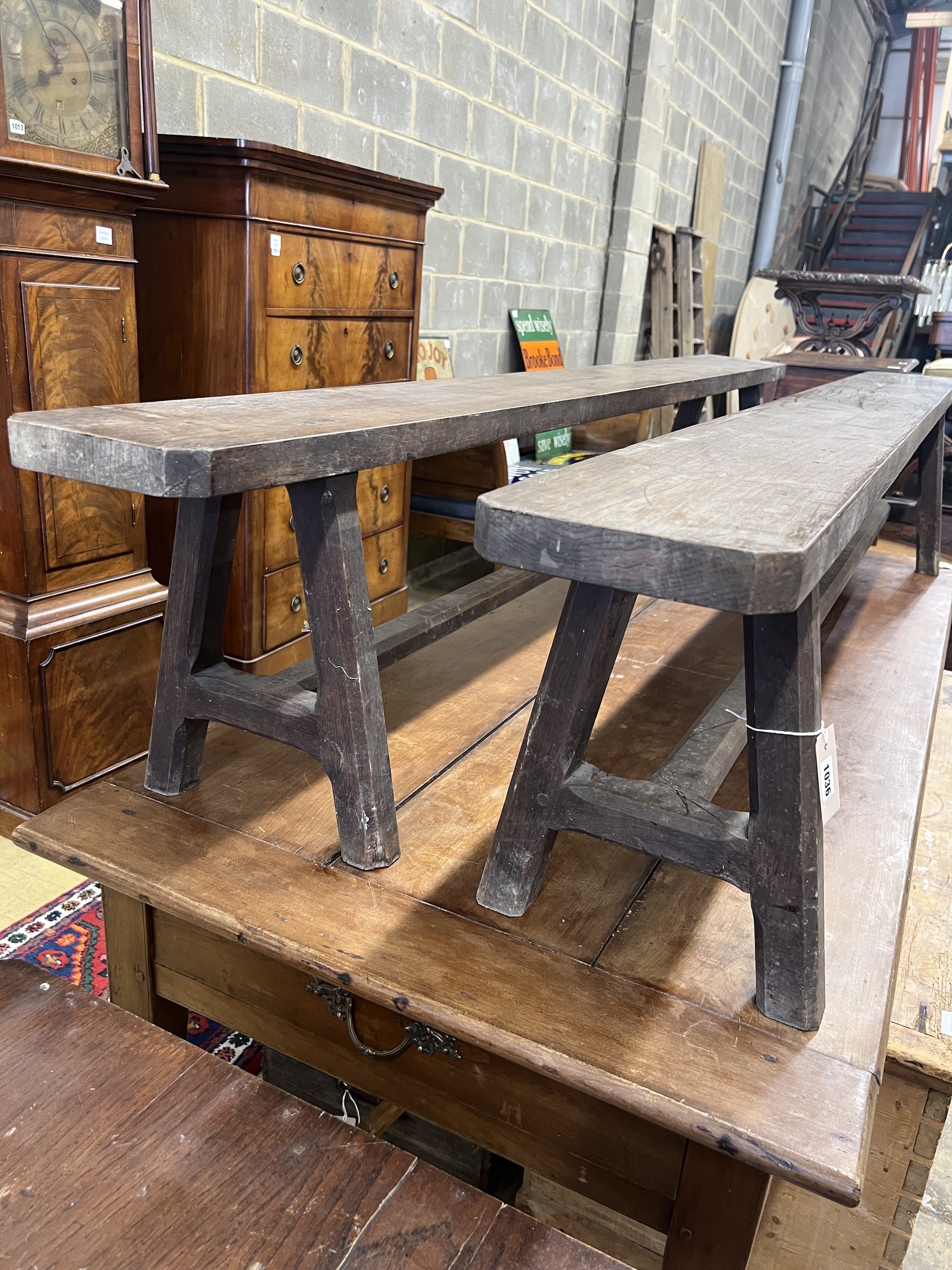 A pair of late 19th century French oak benches, length 210cm, depth 20cm, height 42cm